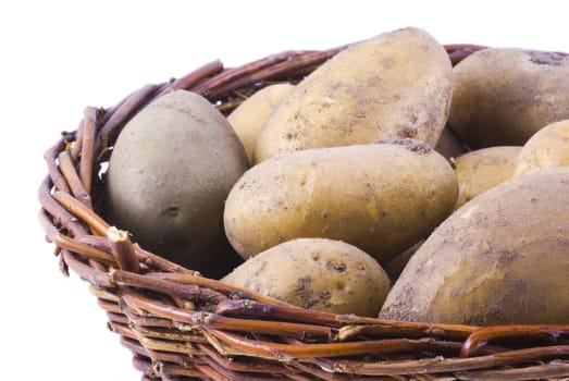 Macro photo of a basket full of potatoes, isolated on white.
