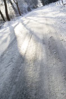 Icy road on the end of the afternoon, photo taken from a low point of view.