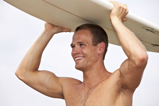 young man holding a surf board outdoors