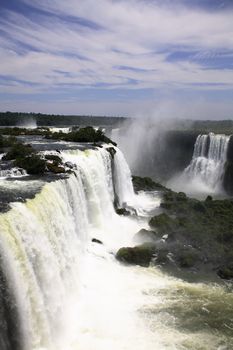 The Iguassu (or Iguazu) Falls is one of the largest masses of fresh water on the planet and divides, in South America, Brazil, Paraguay and Argentina. The waterfall system consists of 275 falls along 2.7 kilometres (1.67 miles) of the Iguazu River. Some of the individual falls are up to 82 metres (269 feet) in height, though the majority are about 64 metres (210 feet).