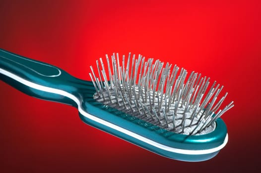Hairbrush for hair on a dark red background