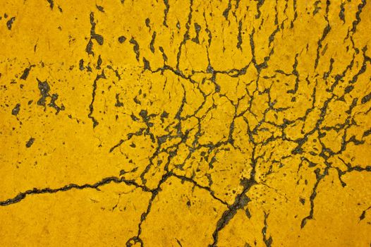 Close-up detail of yellow cracked and flaking paint, suitable for abstract backgroud.