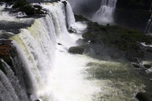 The Iguassu (or Iguazu) Falls is one of the largest masses of fresh water on the planet and divides, in South America, Brazil, Paraguay and Argentina. The waterfall system consists of 275 falls along 2.7 kilometres (1.67 miles) of the Iguazu River. Some of the individual falls are up to 82 metres (269 feet) in height, though the majority are about 64 metres (210 feet).