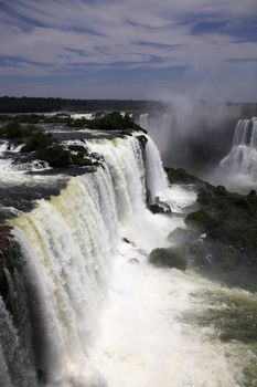 The Iguassu (or Iguazu) Falls is one of the largest masses of fresh water on the planet and divides, in South America, Brazil, Paraguay and Argentina. The waterfall system consists of 275 falls along 2.7 kilometres (1.67 miles) of the Iguazu River. Some of the individual falls are up to 82 metres (269 feet) in height, though the majority are about 64 metres (210 feet).