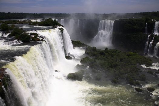 The Iguassu (or Iguazu) Falls is one of the largest masses of fresh water on the planet and divides, in South America, Brazil, Paraguay and Argentina. The waterfall system consists of 275 falls along 2.7 kilometres (1.67 miles) of the Iguazu River. Some of the individual falls are up to 82 metres (269 feet) in height, though the majority are about 64 metres (210 feet).