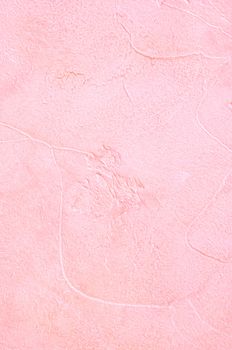 Light pink plaster with a deep relief on a wall