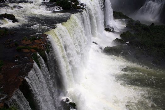 The Iguassu (or Iguazu) Falls is one of the largest masses of fresh water on the planet and divides, in South America, Brazil, Paraguay and Argentina. The waterfall system consists of 275 falls along 2.7 kilometres (1.67 miles) of the Iguazu River. Some of the individual falls are up to 82 metres (269 feet) in height, though the majority are about 64 metres (210 feet).