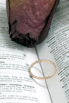 Wedding Ring and heart shaped shadow over a Bible

