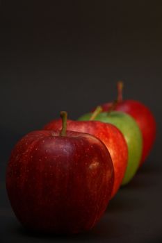 A line of apples with one exception.