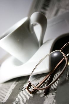 cup of coffee, newspaper and glasses