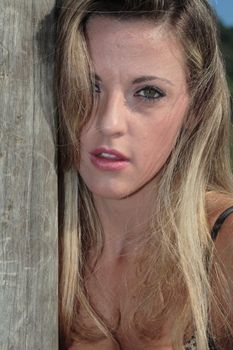 A blonde, 20-30 year old female model on the beach, in Florian�polis - Brazil. This is part of a series. Have a look at the other photos of this model in various outfits and poses.