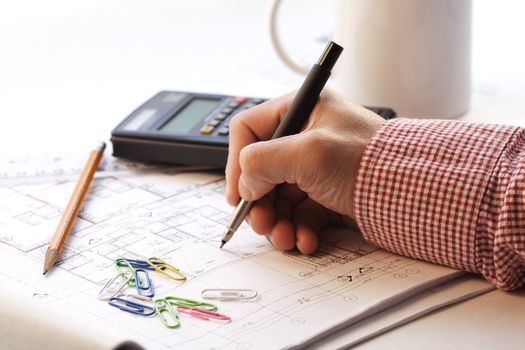 An architect working on a house blueprint