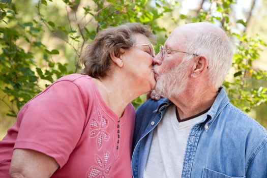 Loving Senior Couple Kissing Enjoying the Outdoors Together.