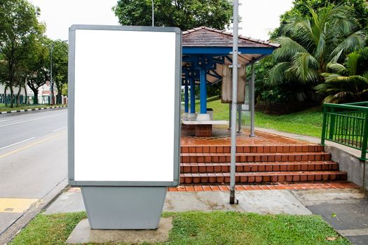 Blank billboard display at bus stop with clipping path for your advertising