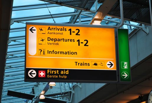 Airport sign: arrival, departures, first aid. Amsterdam Schiphol.