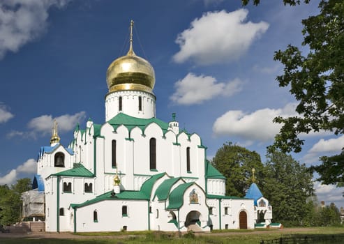 Russian cathedral with gold cupola, bell-tower and icons over entrances