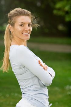 Blonde girl in nature green park exercising yoga, fitness program