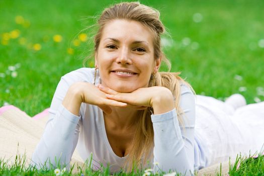 Blonde girl in nature green park relaxing and chilling out