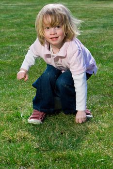 Cute young caucasian boy playing football or soccer outdoors