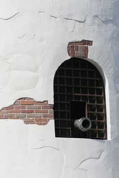 cannon on a opened window of a castle