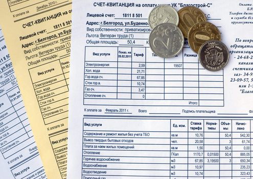 Utility bills and pile of coins