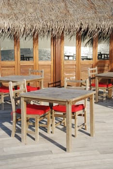 beautiful photo of a typical restaurant setting in a maldivian island (ocean reflection)