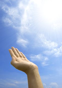 hand hold against blue sky 