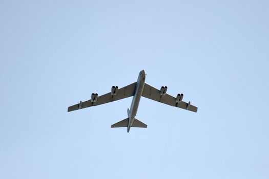 Aircraft flying high into the blue sky