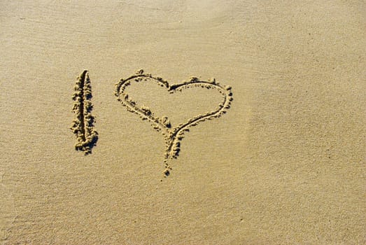 heart on sand at the beach or sea