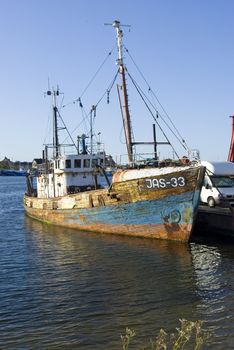 ruined ship in port with rust