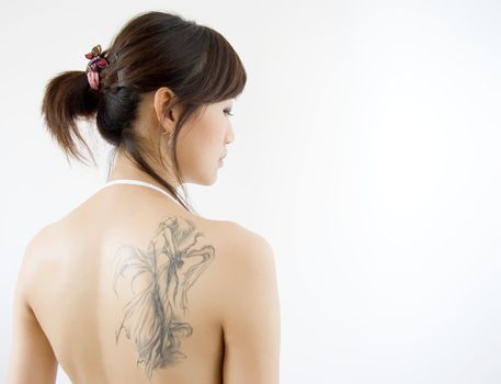 rear view of adult woman with tattoo