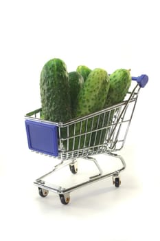 Gherkins in a shopping cart on a white background