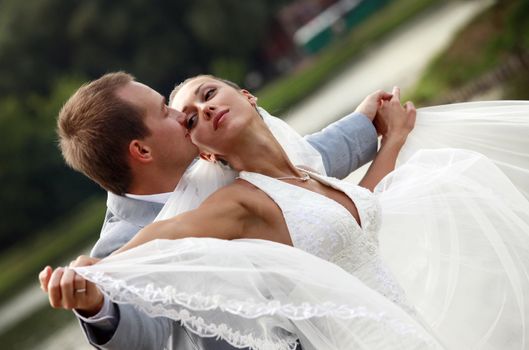 Newly-married couple in park