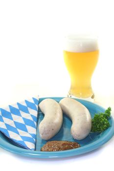 White sausage with sweet mustard and pretzels on a white background