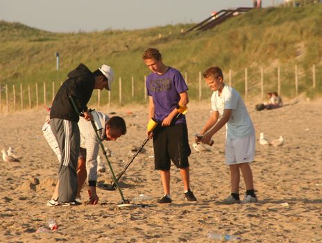 Boys with metal detectors at the beach