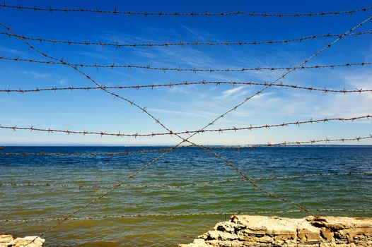 rocky coast with a wire entanglement barbed