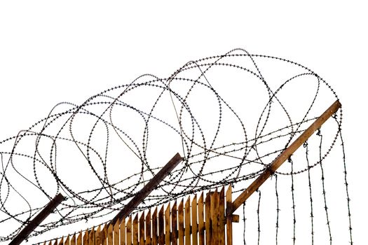Rusty metallic fence topped with barbed wire isolated with cilpping path