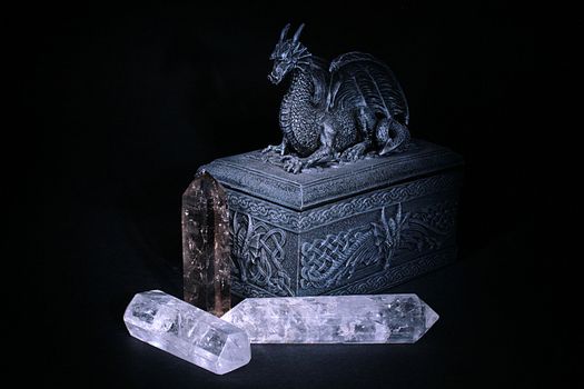 The casket on which cover lies a dragon and before a casket crystals for predictions lie.