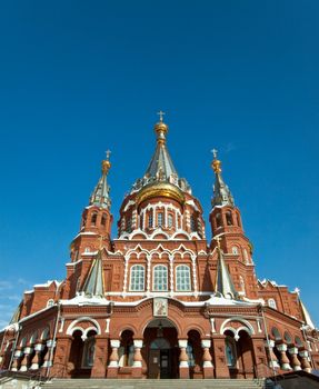 Picture is very beautiful building, on a background of sky and clouds