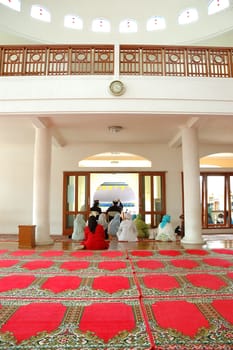 masjid hall with red carpet and white marble wall
