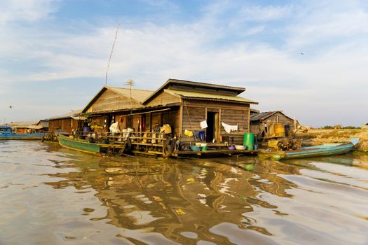 Image of a floating wooden house at the Chong Kneas Floating Village, located at the edge of the Tonle Sap Lake of Cambodia.