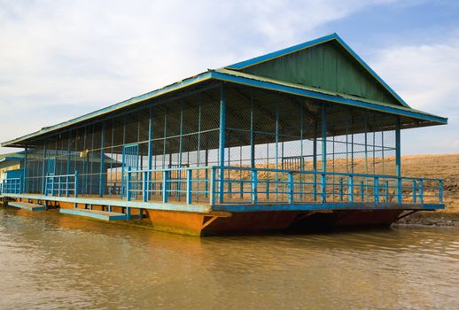 Image of a floating basketball court at the Chong Kneas River, located at the edge of the Tonle Sap Lake of Cambodia.