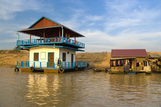 Image of wooden boathouses at the Chong Kneas Floating River, located at the edge of the Tonle Sap Lake of Cambodia.