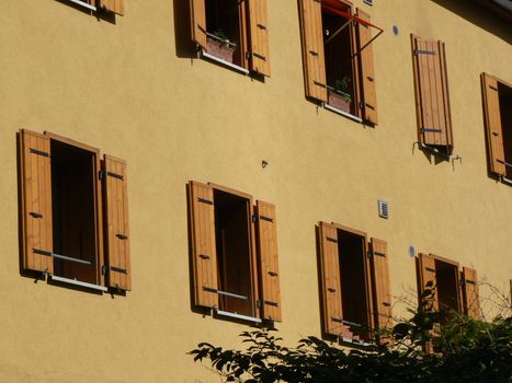 Orange house with several windows and shutters