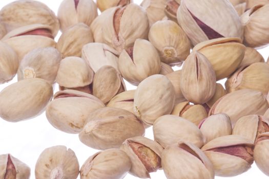 Isolated macro image of natural (non bleached) Pistachio nuts.