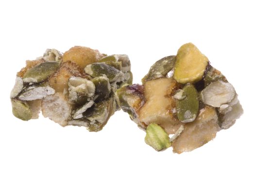 Isolated macro image of crunchy pumpkin and pistachio bites.