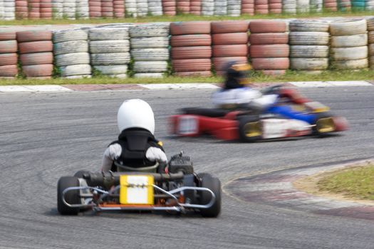 Image of go-kart racers competing at the KKS-AAM Malaysian Kart Championship 2009, held at Sepang International Karting Circuit, Sepang, Selangor, Malaysia on 7 June, 2009. Image intentionally taken with motion blur to portray speed.