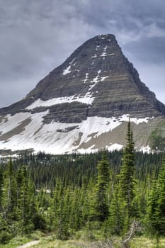 A high mountain peak, carved by glaciers and shot in hdr.