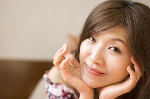 Young Asian women lying on bed with smiling face 