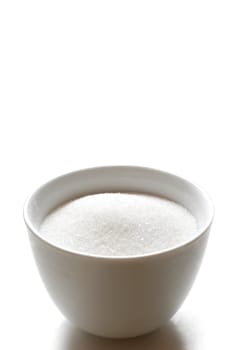 Sugar in a bowl isolated on white